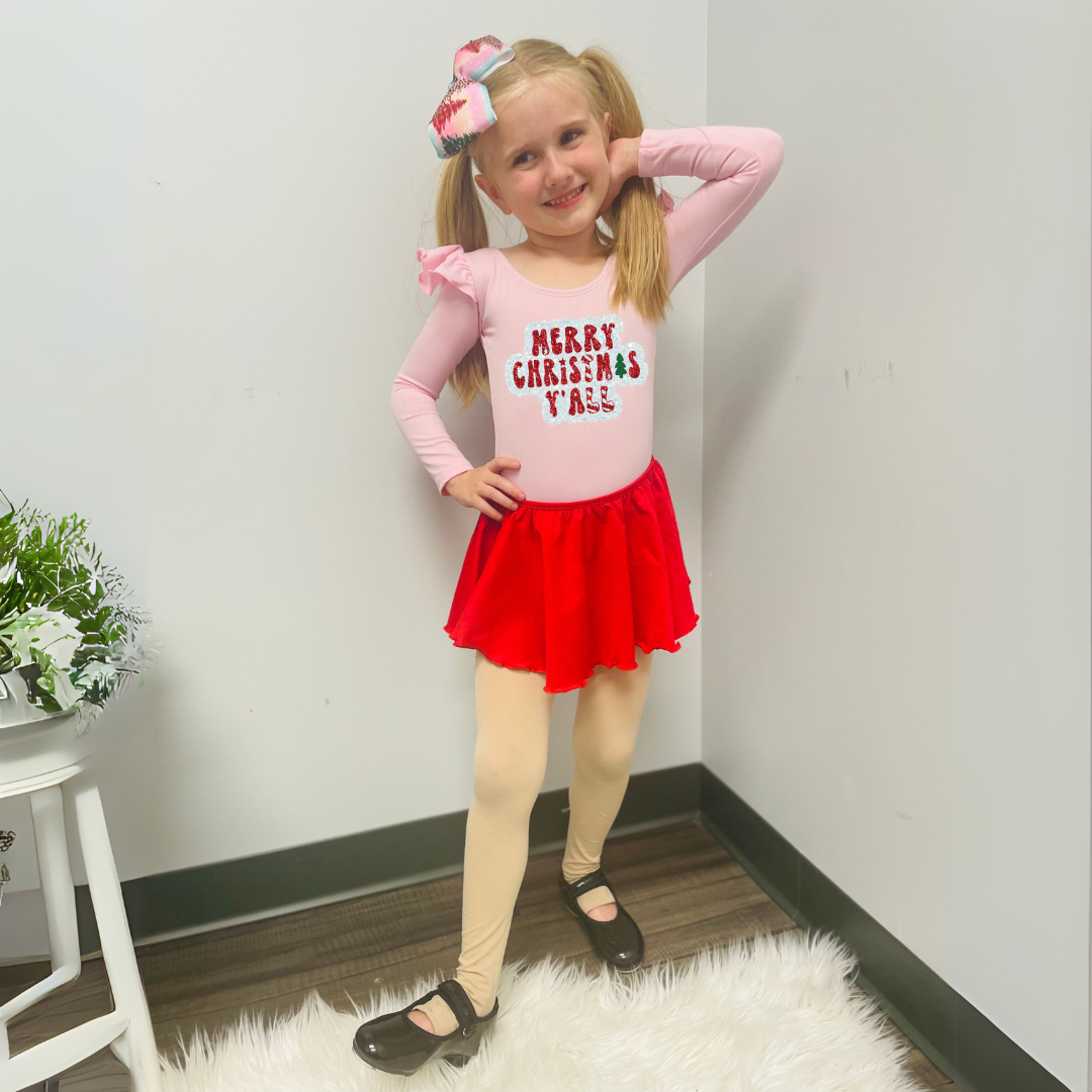 Girl wearing Light Pink Long Ruffle Sleeve Leotard with "Merry Christmas Y'all" in white, red and green glitter vinyl.