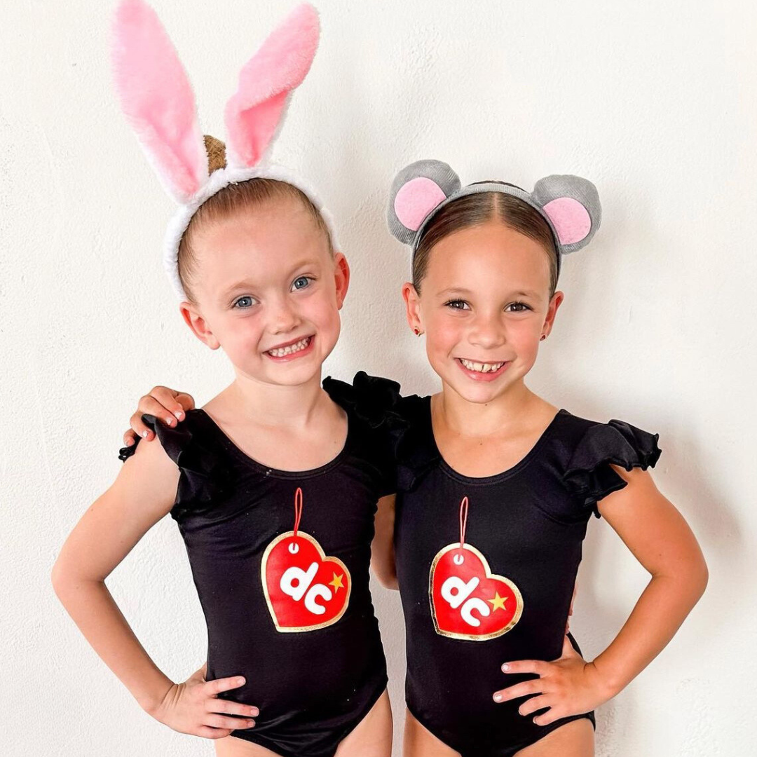 Two girls with Black ruffle sleeve leotards with Beanie Pal design.