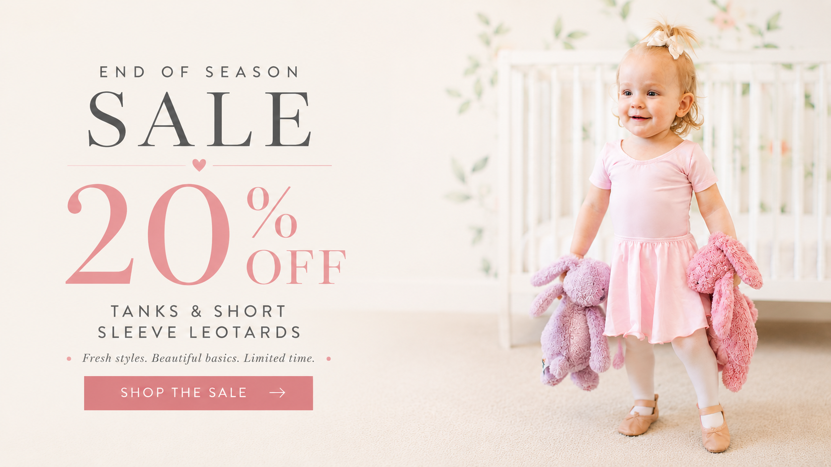 A promotional banner for a children's clothing sale, featuring a young toddler girl in a pink leotard and dress holding two plush teddy bears on the right, next to large sale text on the left.