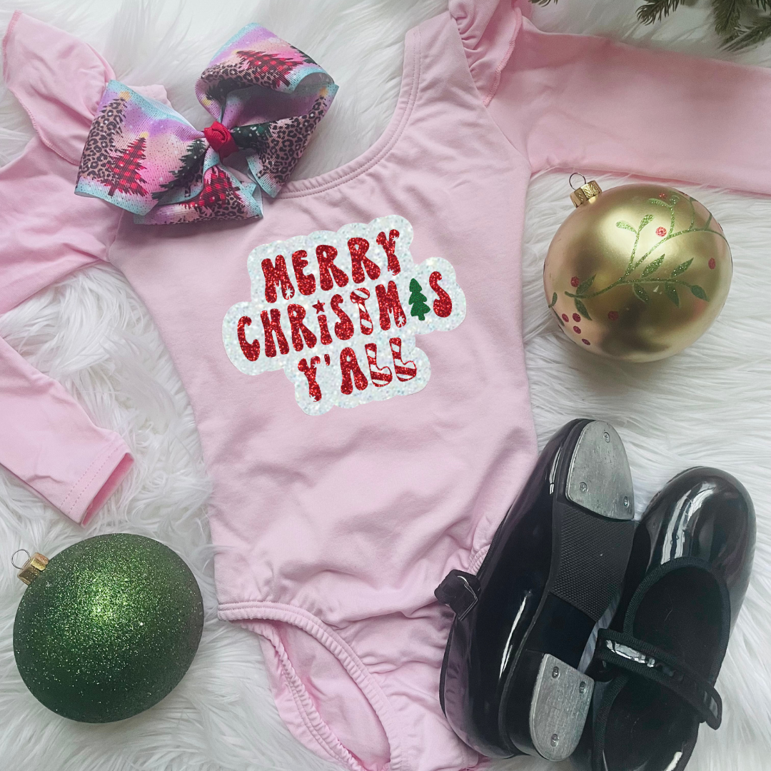 Light Pink Long Ruffle Sleeve Leotard with "Merry Christmas Y'all" in white, red and green glitter vinyl next to tap shoes