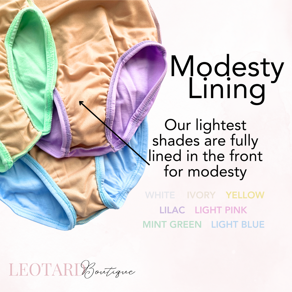 A stack of colorful children's leotards in various colors including white, ivory, yellow, lilac, light pink, mint green, and light blue. Text above the leotards reads "Modesty Lining" and "Our lightest shades are fully lined in the front for modesty." 