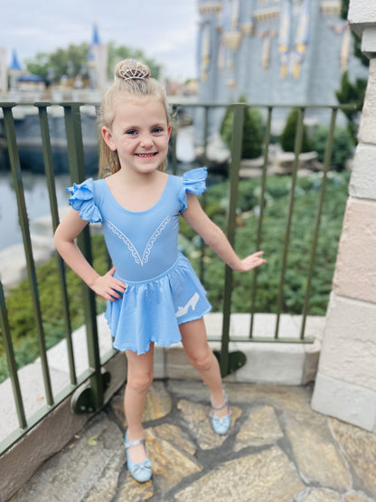 Girl in Stroke of Midnight matching leotard and skirt in front of a castle.